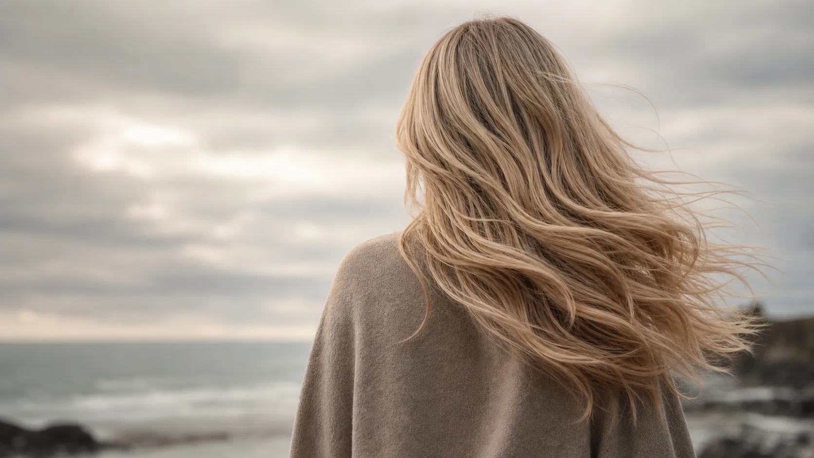 Sunlit blonde hair moving in the coastal breeze